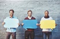 Theyve got some thoughts to share. Portrait of a group of young men holding speech bubbles against a brick wall.