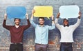 Weve got a few thoughts to share. Portrait of a group of young men holding speech bubbles against a brick wall.