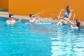 Young people splashing water in swimming pool Royalty Free Stock Photo