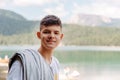 portrait of a guy on the background of a mountain lake