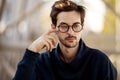 Portrait of a guy with glasses posing outdoors Royalty Free Stock Photo