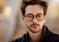 Portrait of a guy with glasses posing outdoors Royalty Free Stock Photo