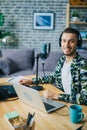 Portrait of guy in headphones in recording studio using mic looking at camera Royalty Free Stock Photo