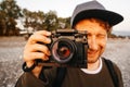 Portrait of a guy taking a photo with a professional camera. Close up portrait of photographer taking pictures with digital camera