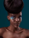 Portrait, hair care and makeup with a model black woman in studio on a blue background for beauty. Face, hairstyle and Royalty Free Stock Photo