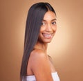 Portrait, hair care and woman with a smile, cosmetics and skincare on a brown studio background. Face, person and model Royalty Free Stock Photo