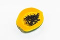 Portrait of a half fresh green medium sized papaya fruit isolated on a white background Royalty Free Stock Photo