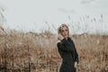 Portrait of half turned woman on bulrush background Royalty Free Stock Photo