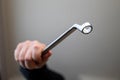 A portrait of a hand of a person or construction worker holding a metal chrome box end wrench tool Royalty Free Stock Photo