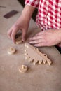 Portrait hands carpenter wood element wheel dinosaur toy at