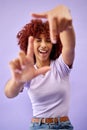 Portrait, hands frame and happy woman wink in studio isolated on a purple background. Face, finger border and person