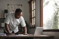 Portrait of handsome African black young business man working on laptop at office desk Royalty Free Stock Photo