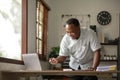 Portrait of handsome African black young business man working on laptop at office desk Royalty Free Stock Photo