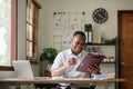 Portrait of handsome African black young business man working on laptop at office desk Royalty Free Stock Photo