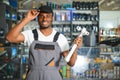 Portrait of a handsome african salesman in an auto parts store. The concept of car repair Royalty Free Stock Photo