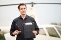 Portrait of handsome aircraft maintenance mechanic point the finger to the maintenance book and smiling gently in front of the Royalty Free Stock Photo