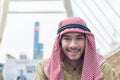 Portrait of handsome arab businessman is smiling in downtown with building background
