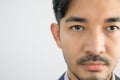 Portrait of a handsome Asian man with a beard in a gray shirt with suit making a straight face Royalty Free Stock Photo