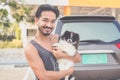 Portrait of a handsome Asian man with short hair wearing a dark gray tank top and blue jeans. Hold his Pomeranian and play with it Royalty Free Stock Photo