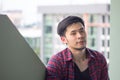 Portrait of handsome Asian man sits on the roof of a high-rise b Royalty Free Stock Photo