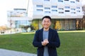 Portrait handsome Asian man a university college teacher, businessman, scientist Cheerful happy educator. Standing background