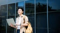 Portrait of handsome Asian student using computer laptop Royalty Free Stock Photo