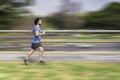 Portrait of handsome attractive mature bearded athletic latin man guy 40s in casual blue t-shirt running at a park Royalty Free Stock Photo