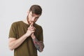 Portrait of handsome attractive mature bearded tattooed caucasian man with short brown hair in casual brown tshirt