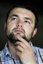 Portrait of handsome bearded confident intelligent modern photogenic young man with short haircut and kind black eyes looking tho