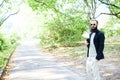 Portrait of handsome bearded man drinking hot tea outdoor in trip on foot. Strong and brave man with beard have a rest