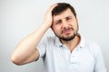 Portrait of a handsome bearded man holding his head with his hand and suffering from headache Royalty Free Stock Photo