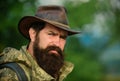 Portrait of handsome bearded man with serious face ond cowboy hat outdoor. Close up masculine face. Royalty Free Stock Photo