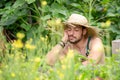 Portrait of bearded man with straw hat relaxing in garden Royalty Free Stock Photo