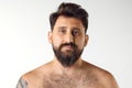 Portrait of handsome bearded mature man with blue eyes posing shirtless against white studio background. Spa Royalty Free Stock Photo