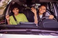 Portrait of handsome beautiful cheerful couple driving car traveling having fun waving hi hello buying new wheel Royalty Free Stock Photo