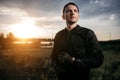 Portrait of handsome biker in sunset on the country road. Royalty Free Stock Photo