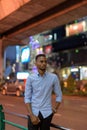 Portrait of handsome black African businessman outdoors in city at night thinking Royalty Free Stock Photo