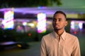 Portrait of handsome black businessman outdoors in city at night thinking Royalty Free Stock Photo