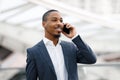 Portrait Of Handsome Black Businessman Talking On Mobile Phone At Airport Royalty Free Stock Photo