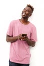 Handsome black man with mobile phone looking away on white background Royalty Free Stock Photo