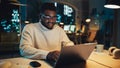 Portrait of a Handsome Black Project Manager Making a Video Call on Laptop Computer in an Evening Royalty Free Stock Photo