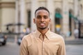 Portrait of handsome black young African businessman smiling outdoors in city Royalty Free Stock Photo