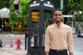 Portrait of handsome black young African businessman smiling outdoors in city Royalty Free Stock Photo