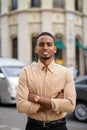 Handsome black young African businessman outdoors in city with arms crossed Royalty Free Stock Photo