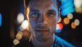 Portrait of Handsome Blonde Man Smiling and Looking at Camera, Standing in Night City with Bokeh Royalty Free Stock Photo