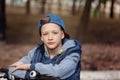 Portrait Handsome boy on a bicycle at asphalt road in the spring park. Royalty Free Stock Photo