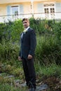 Portrait of handsome bride standing by plants in park Royalty Free Stock Photo