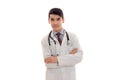 Portrait of handsome brunette male doctor in uniform with stethoscope looking and smiling on camera isolated on white Royalty Free Stock Photo