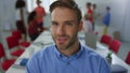 Handsome man looking camera modern office. Businessman posing in meeting room Royalty Free Stock Photo