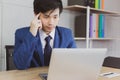 Portrait handsome businessman. Attractive handsome young business man is thinking and working work on laptop computer on desk Royalty Free Stock Photo